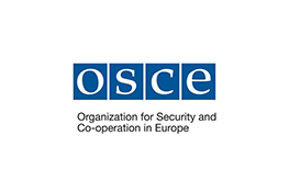 The Organisation for Security and Cooperation in Europe logo - four blue squares with the white text 'O.S.C.E' inside, under which there is the black text 'Organisation for Security and Cooperation in Europe'.