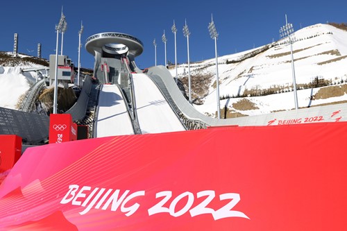 Image of Ski Jump with sign for Beijing 2022 in bright red