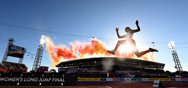 Athlete Jumps With Fireworks In Background