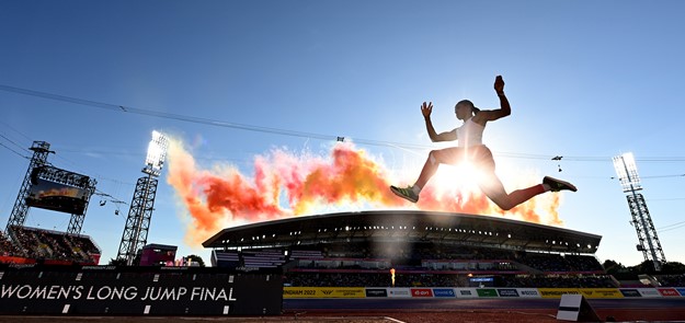 Athlete Jumps With Fireworks In Background