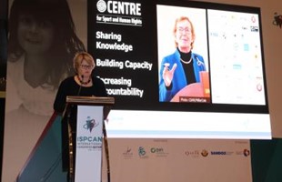 The Centre's CEO standing at podium delivering speech.